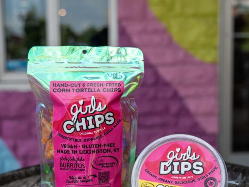 Image of Girls Chips in resealable snack size bag next to a container of Girls Queso