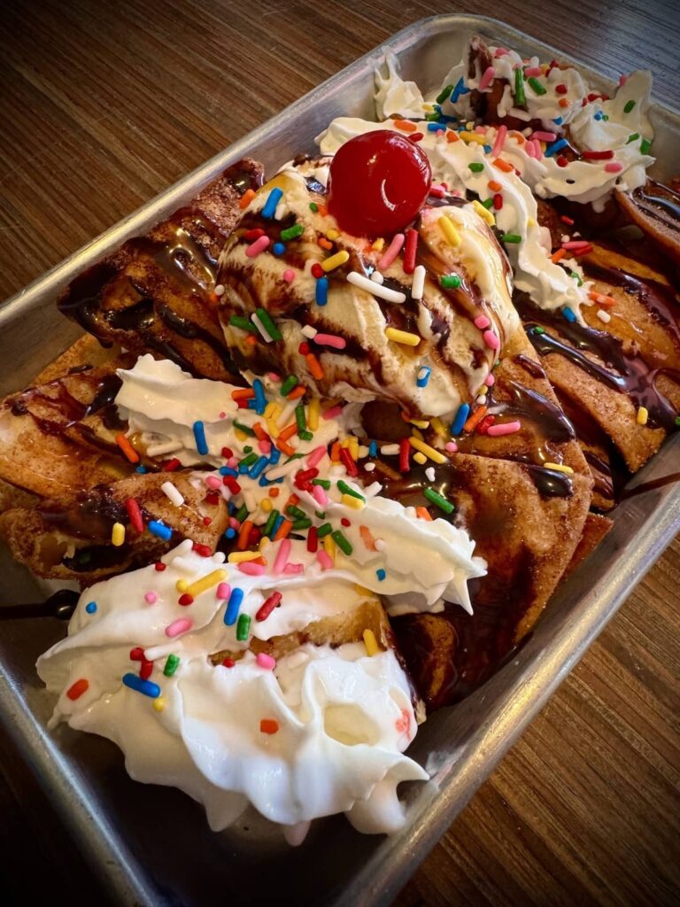 Girls Churro nachos with sprinkles, whip cream and a cherry