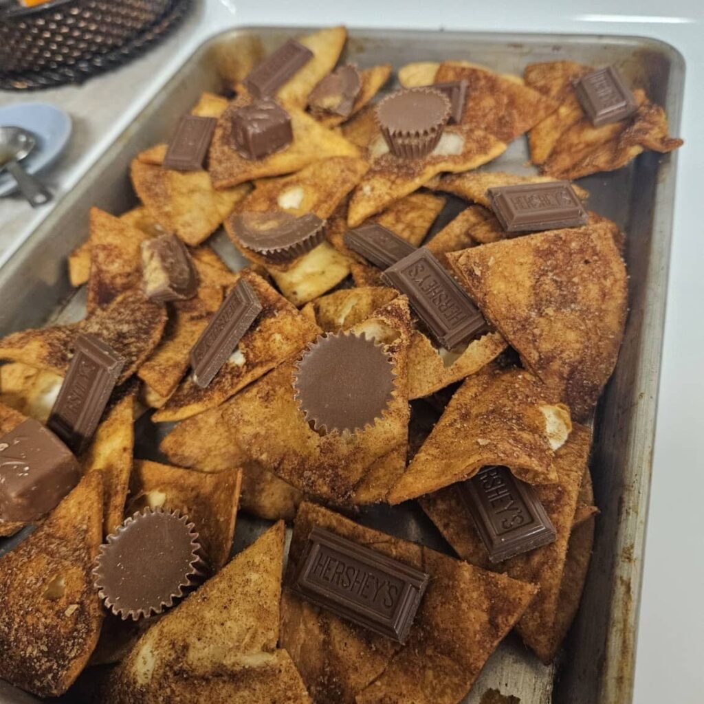 Homemade sweet dessert nachos Girls Churro Chips and chocolate on a baking sheet