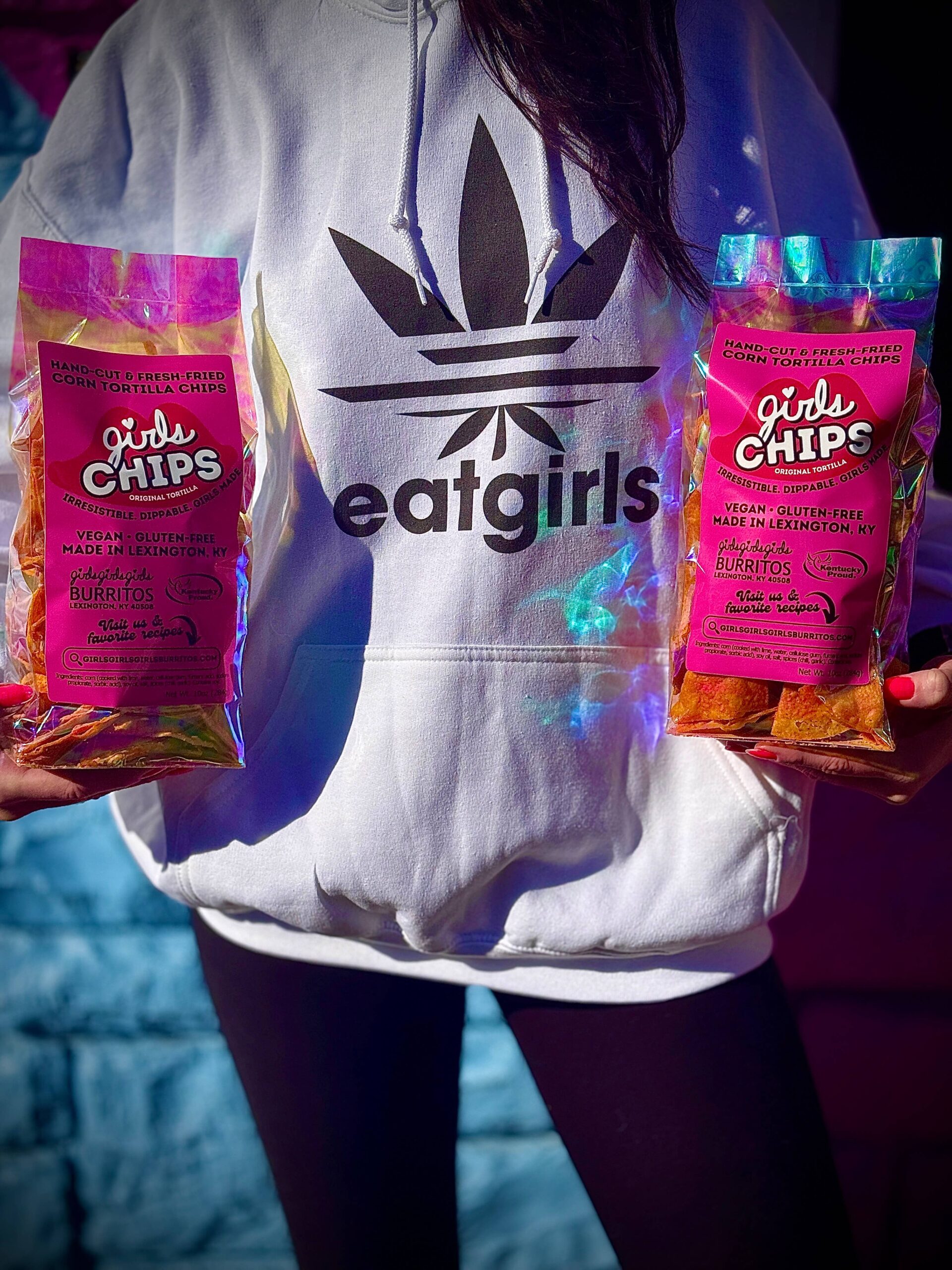 Girls owner holding two bags of Girls Chips